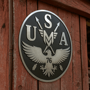 metal USA patch Mericana logo on outside wall of red rustic building